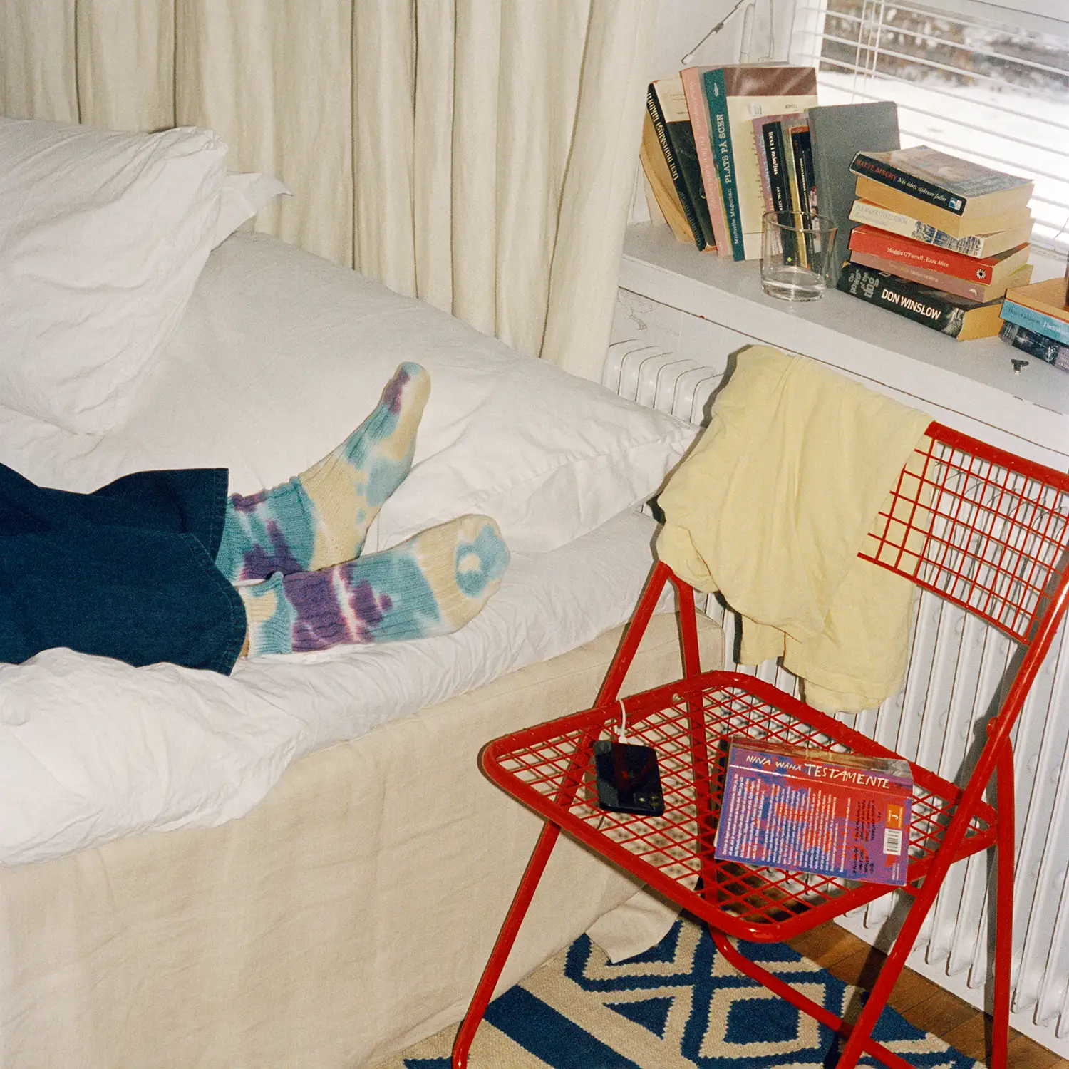 Student lies in bed in apartment with home insurance.