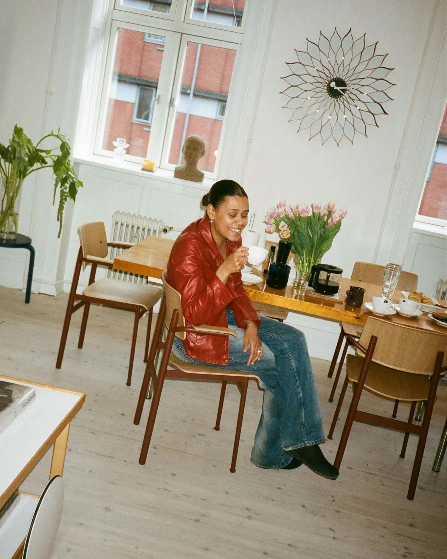 A homeowner drinking coffee in her apartment.