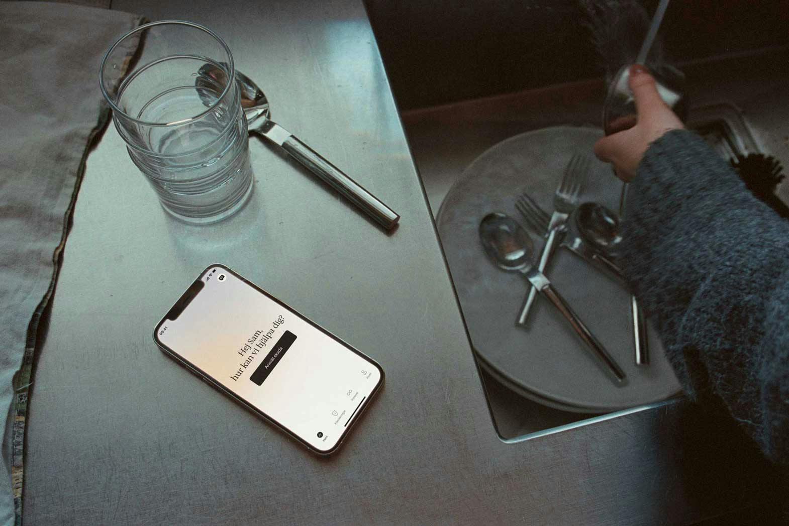 A phone on a kitchen counter next to a sink