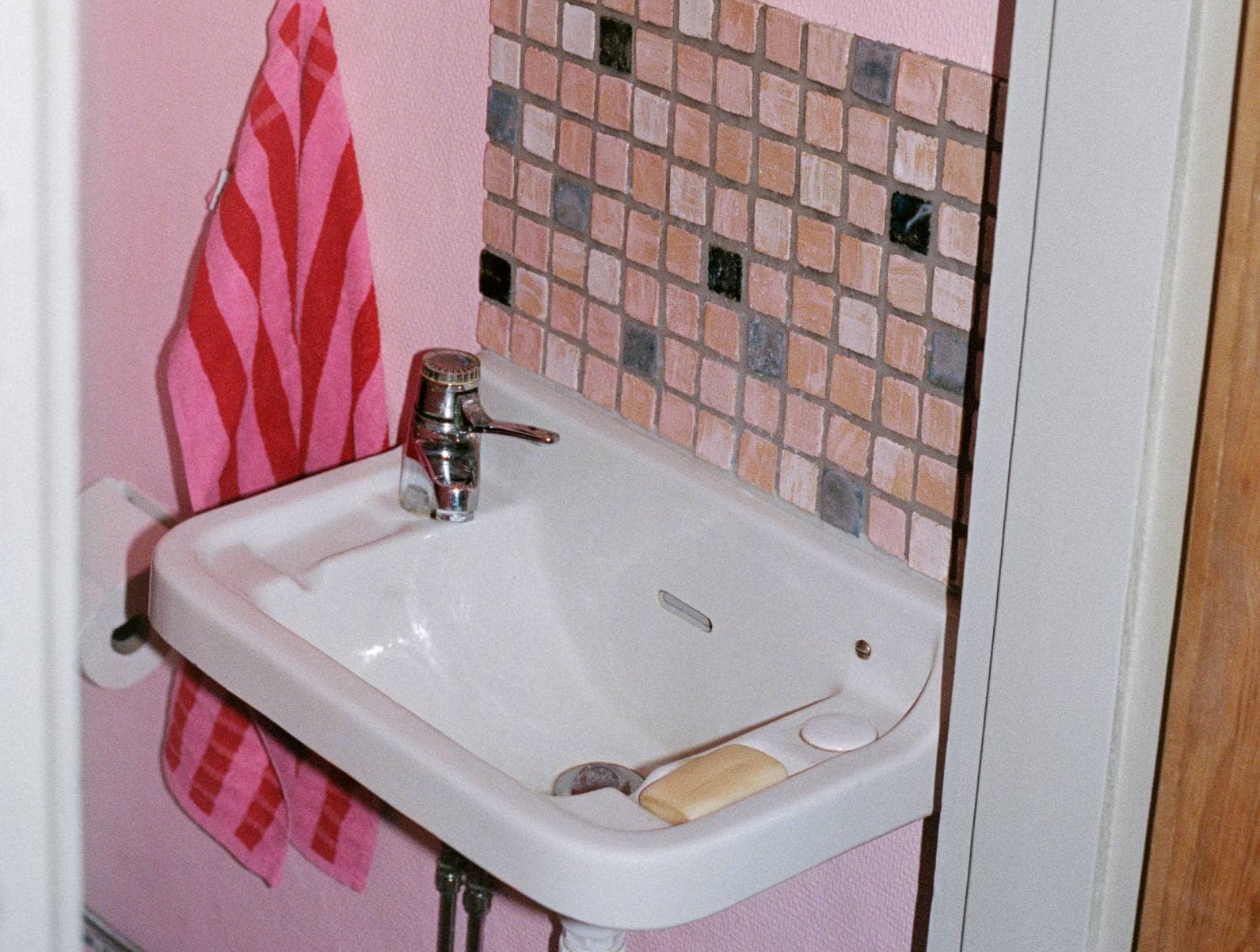 Ett enkelt handfat med kran på toalett